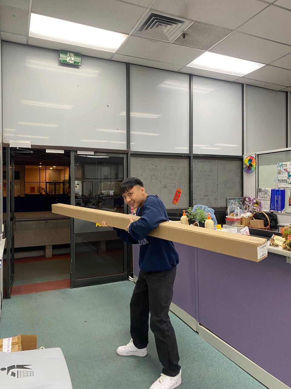 Jarrod Chua carrying a filming backdrop