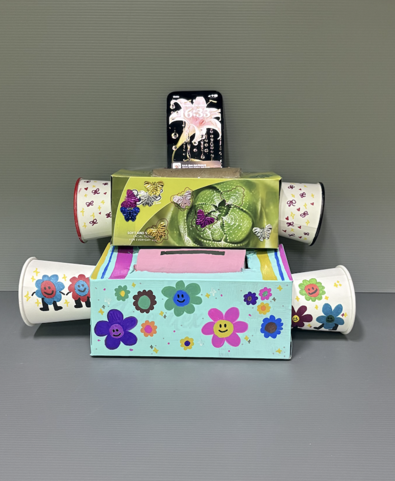 Two DIY speakers decorated with fun, colourful stickers.