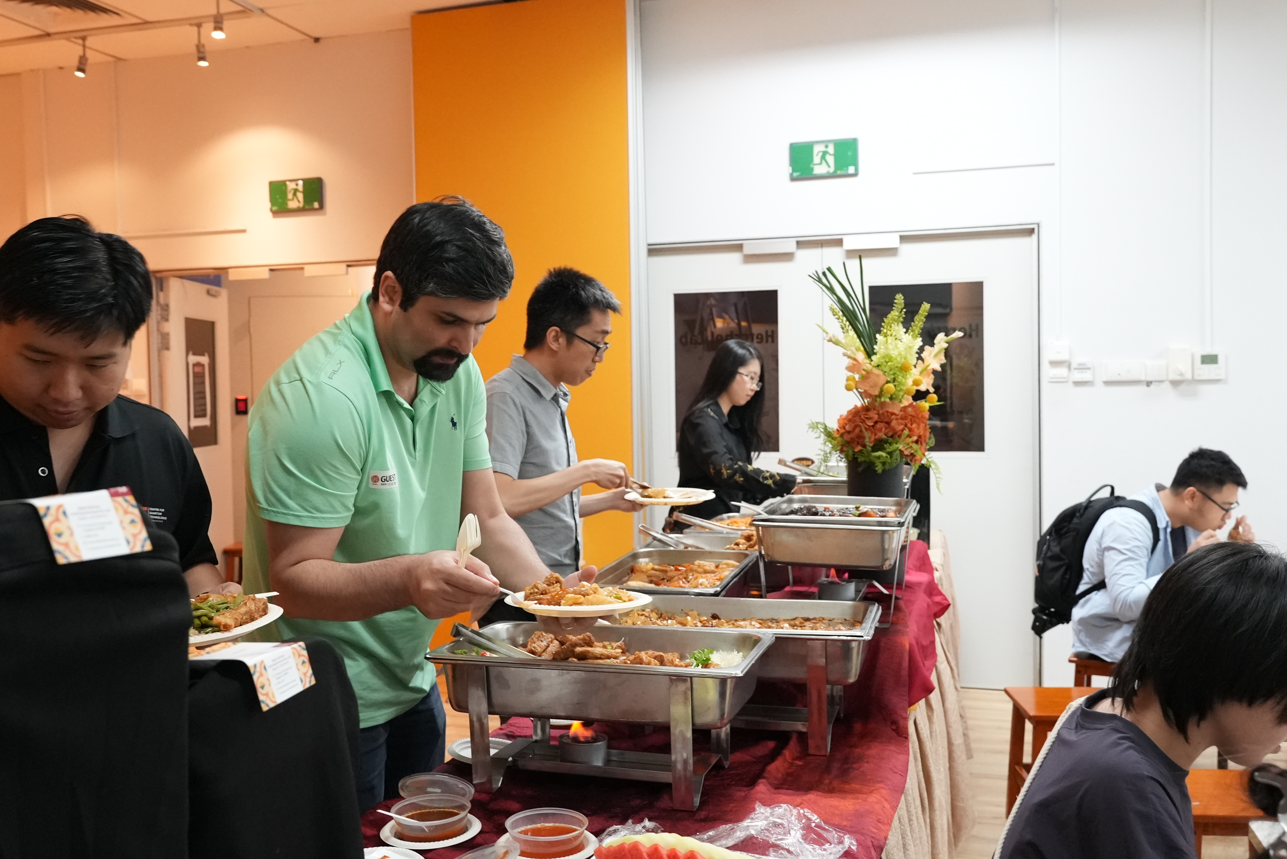 Attendees enjoying a buffet dinner at Science Cafe: Quantum Computing at Science Centre Singapore.