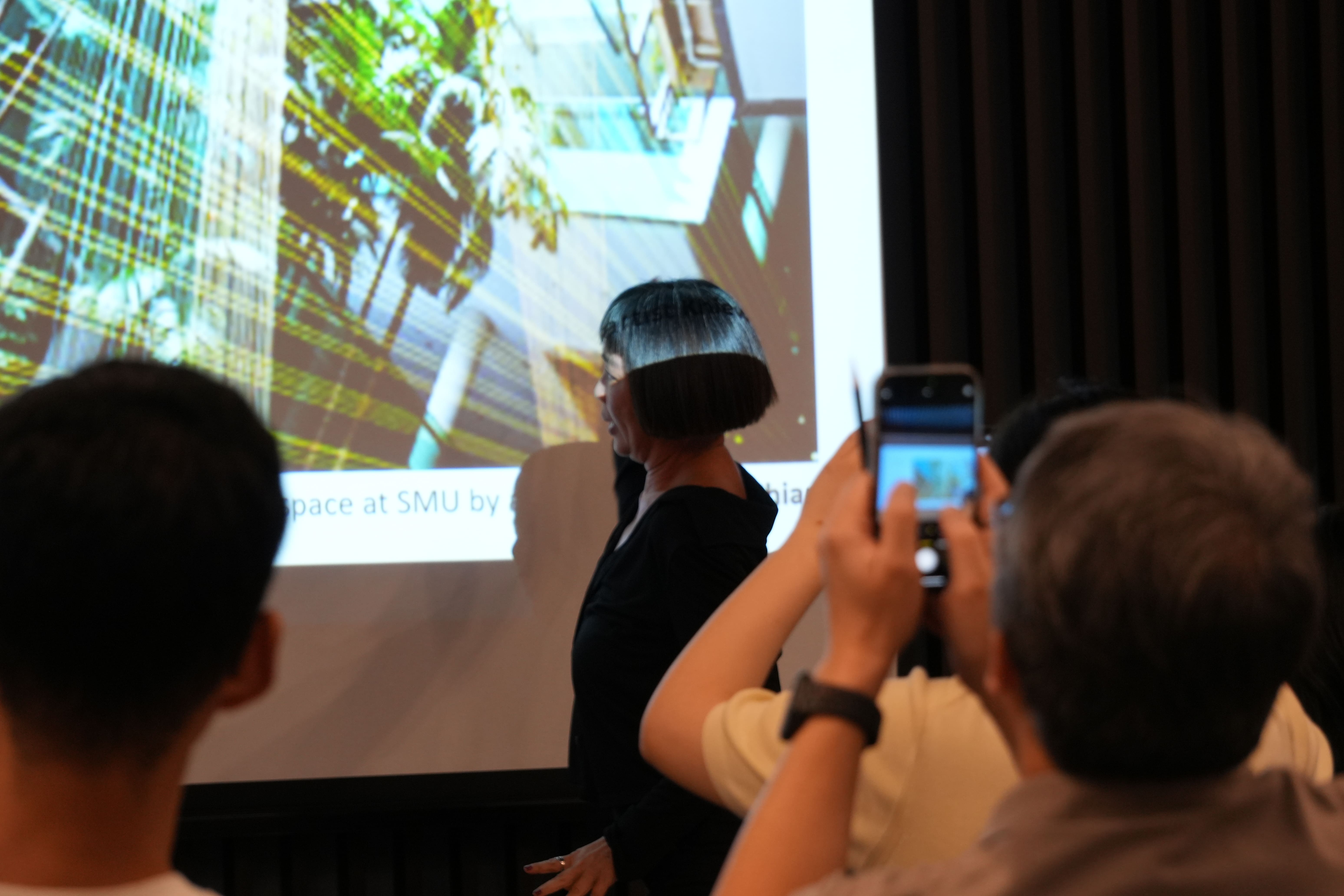 Dr. Joyce Koh presenting her talk, "In Search of the Music of String Theory".