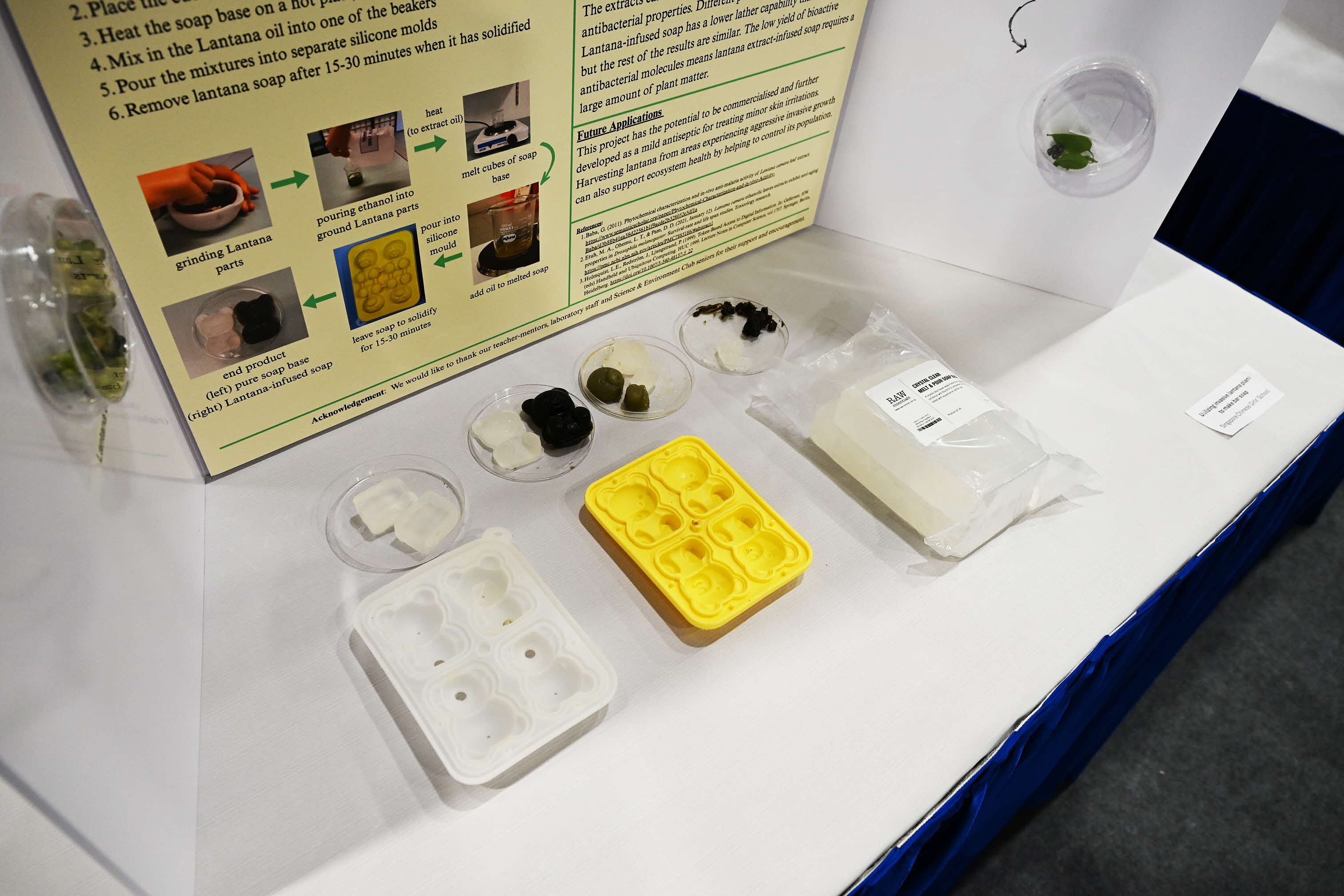 Pure soap base (white) compared to lantana soap (black) at Singapore Chinese Girls' School booth
