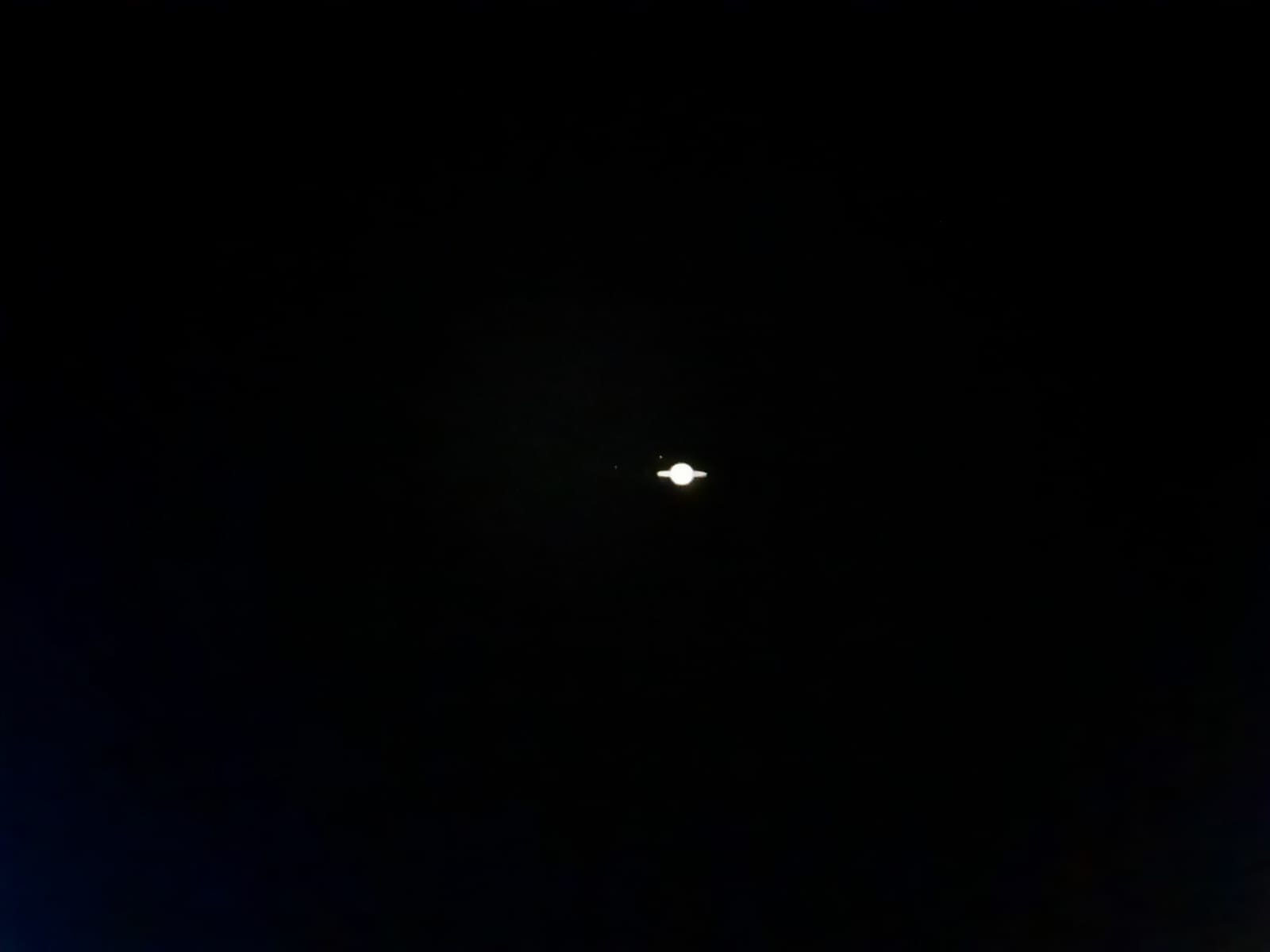 Tiny Saturn photographed with phone pressed to small telescope viewfinder at SCOB on 11/10/2024.