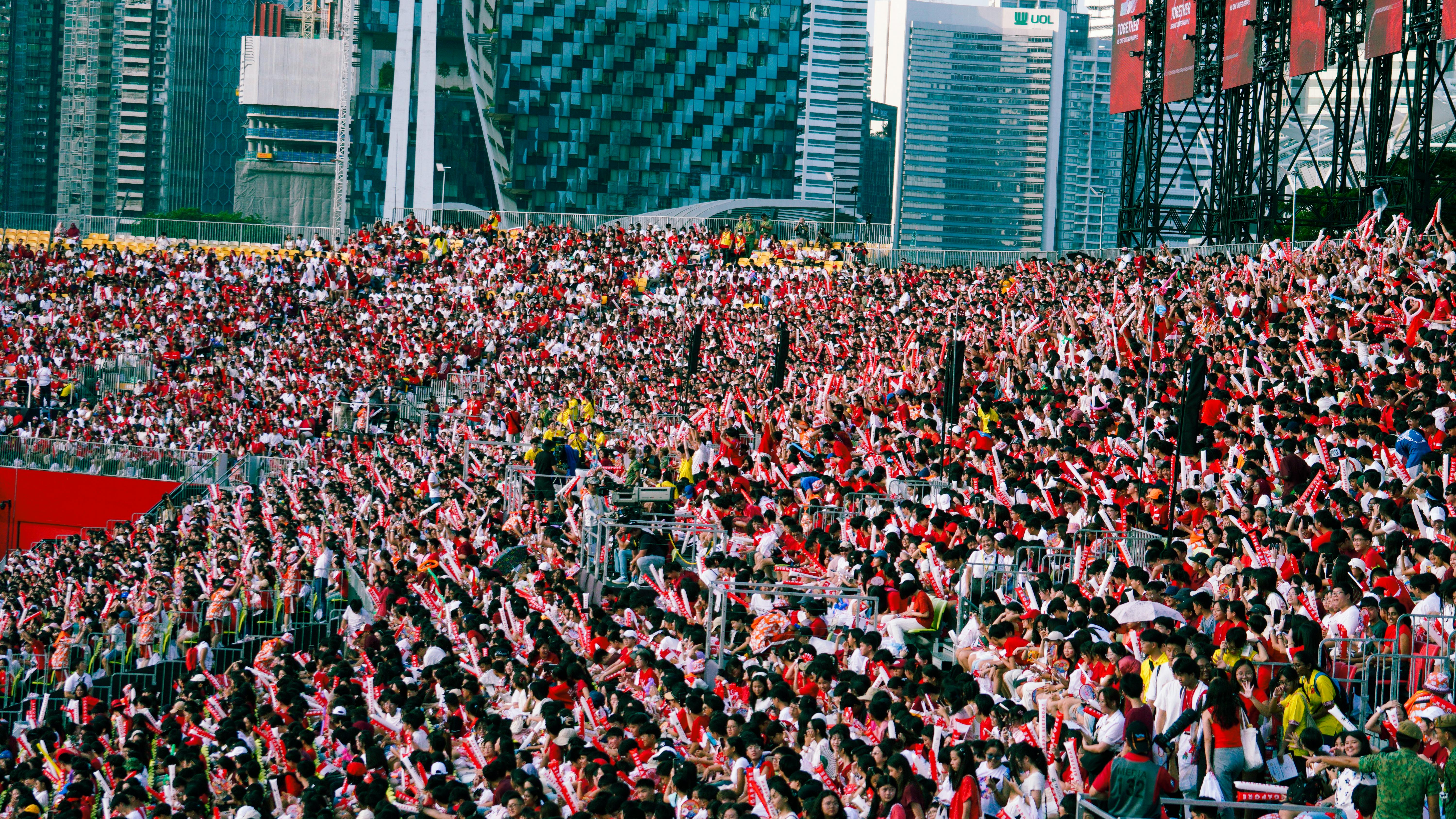 Large crowd of NDP attendees dressed in red and white.